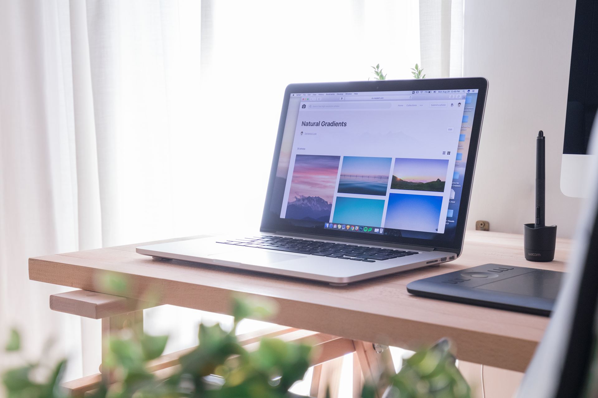 an open laptop computer sitting on top of a wooden desk